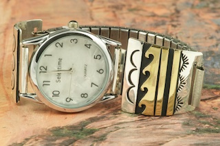 Beautiful Sterling Silver Watch Tips with Gold fill contemporary design. Mens quartz watch with expandable band. Created by Navajo Artist Tommy Singer. Signed.